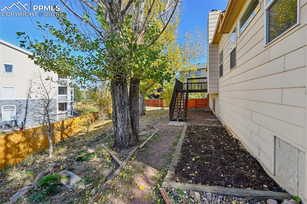 Image 31 of 35: Yard with mature trees and new back fence!