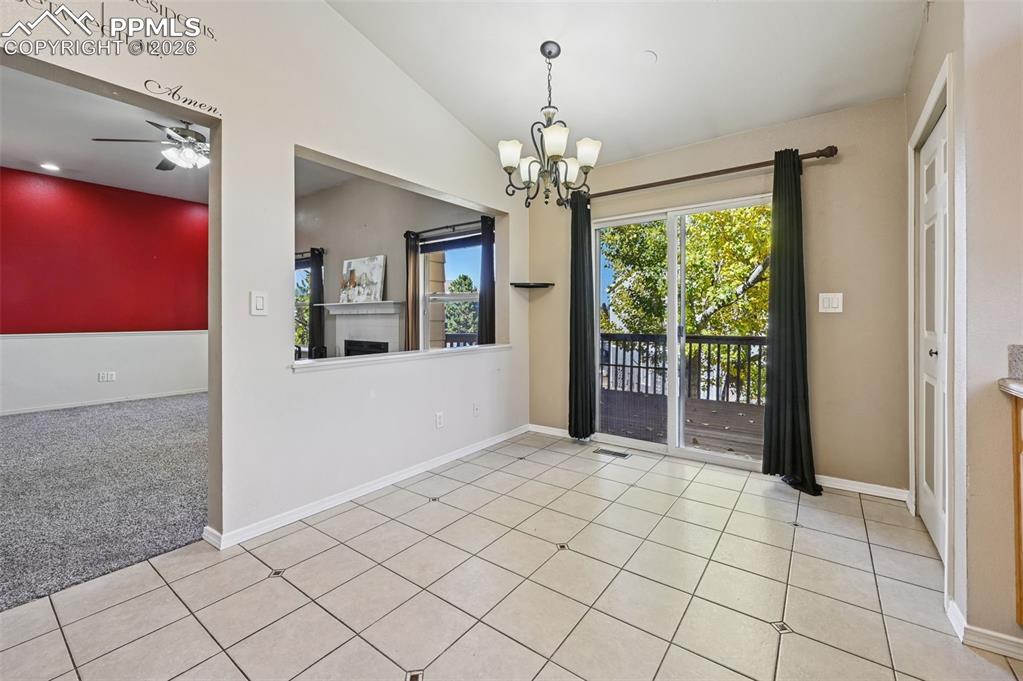 Image 7 of 35: Dining area in the kitchen with walk-out access to the deck