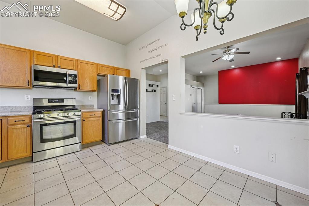 Image 11 of 37: Kitchen with appliances with stainless steel finishes, a chandelier, light