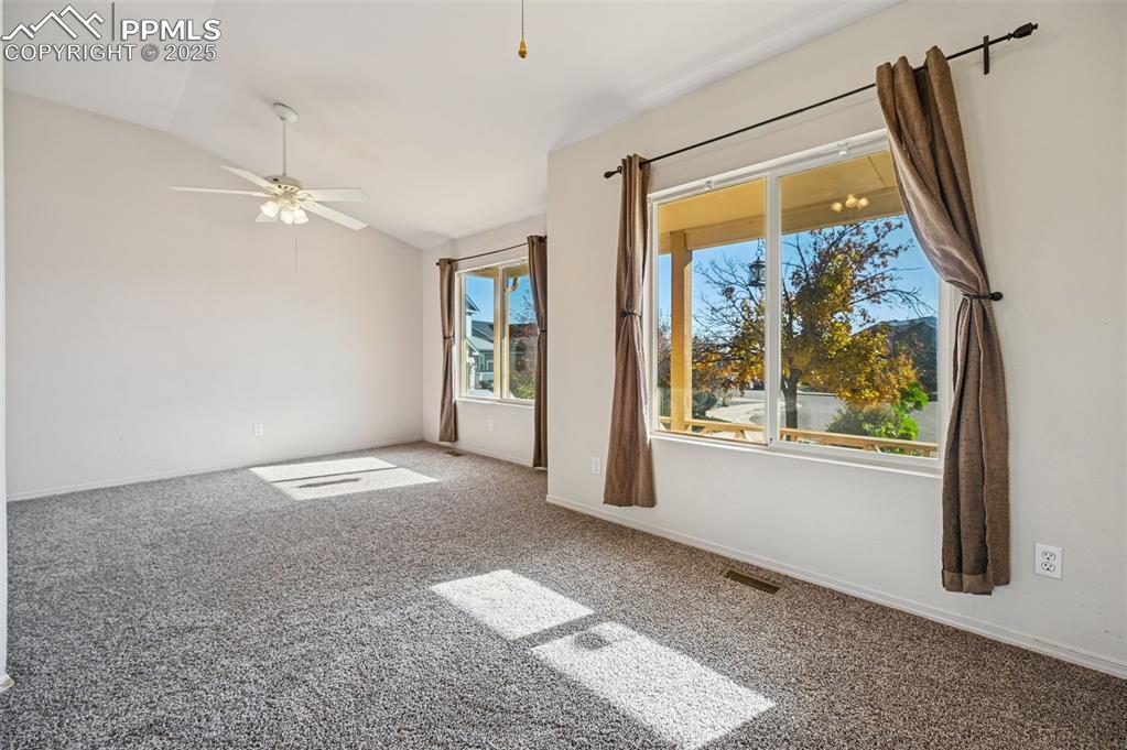 Image 13 of 37: Secondary bedroom on the main level. Plenty of space for an office area.