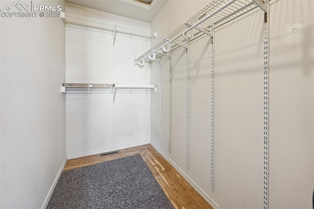 Image 22 of 37: Large walk-in closet in the Primary bedroom with cedar floors