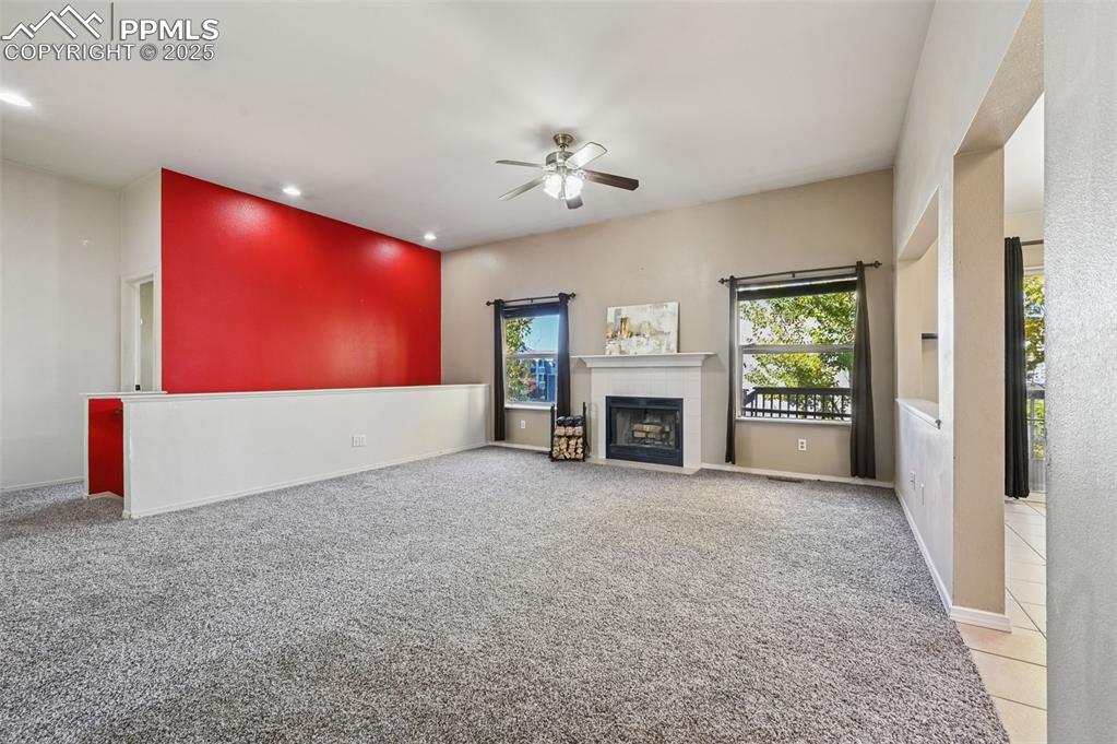 Image 5 of 37: Unfurnished living room featuring light colored carpet, healthy amount of n