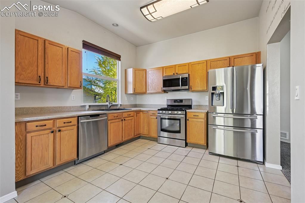 Image 9 of 37: Kitchen with newer stainless steel appliances