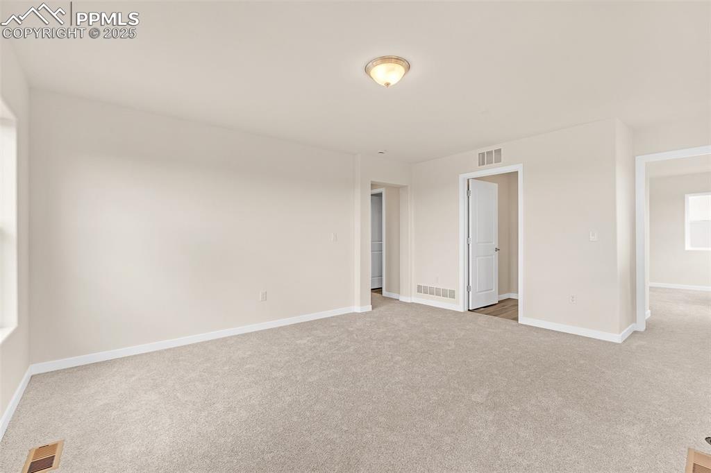 Image 20 of 29: Carpeted spare room featuring baseboards