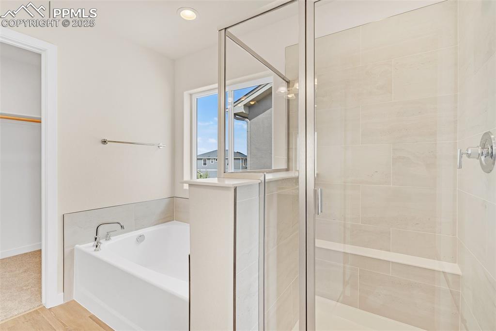 Image 24 of 29: Full bath with a shower stall, a garden tub, recessed lighting, and wood fi