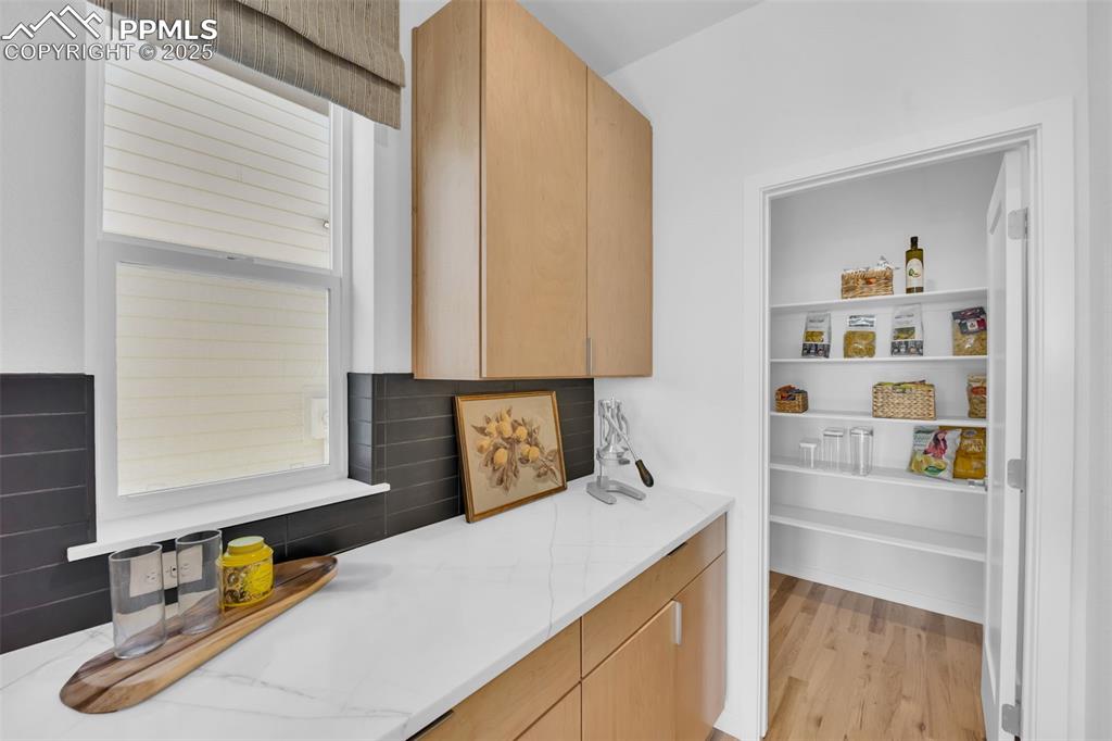 Image 9 of 9: Walk in Pantry with extra cabinet and countertop space