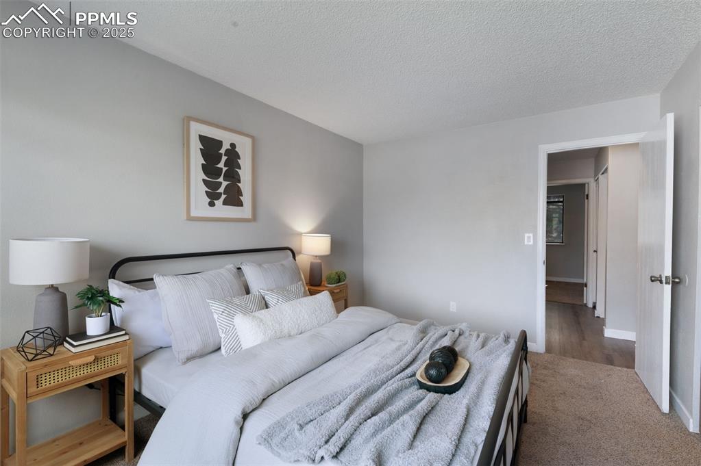 Image 13 of 26: Bedroom featuring a textured ceiling and baseboards