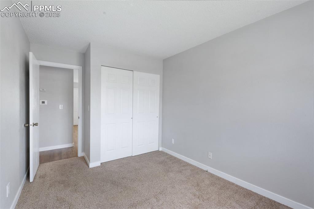 Image 16 of 26: Unfurnished bedroom with carpet floors and a closet