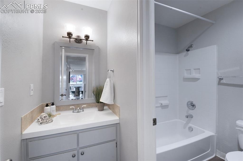 Image 17 of 26: Bathroom featuring shower / tub combination and vanity