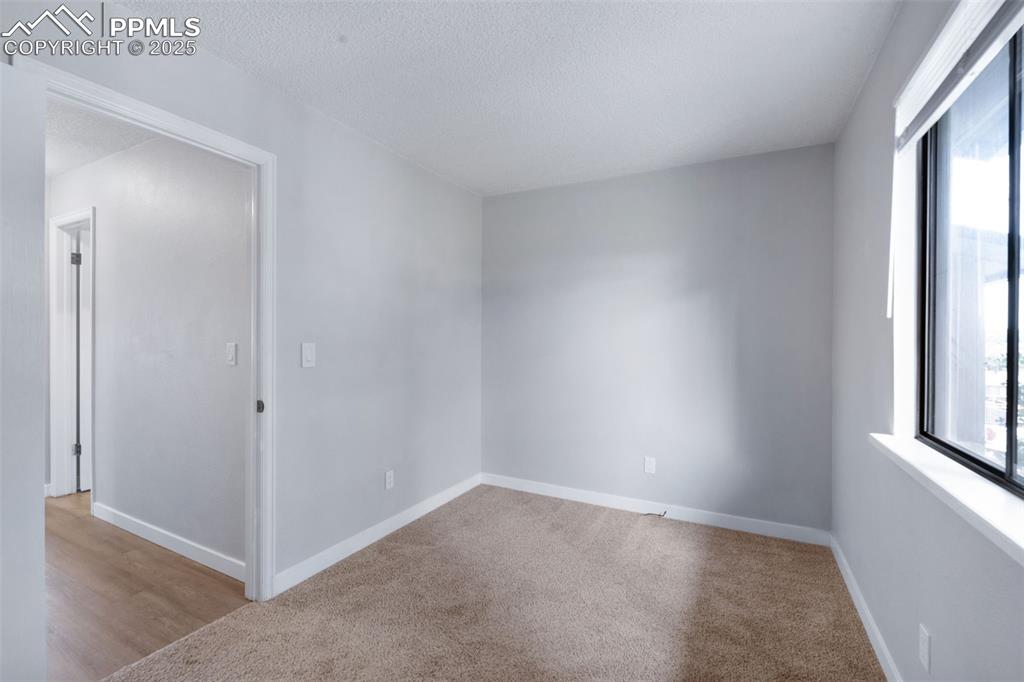 Image 19 of 26: Carpeted spare room featuring a textured ceiling