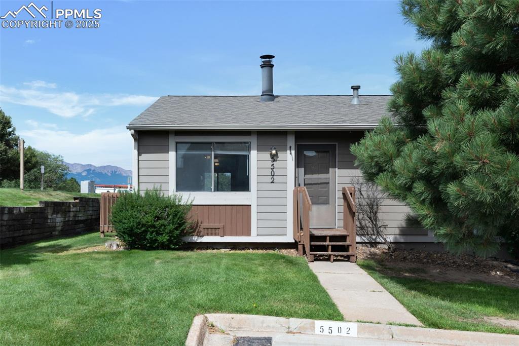 Image 25 of 26: Bungalow-style home featuring a front lawn, roof with shingles, and a mount