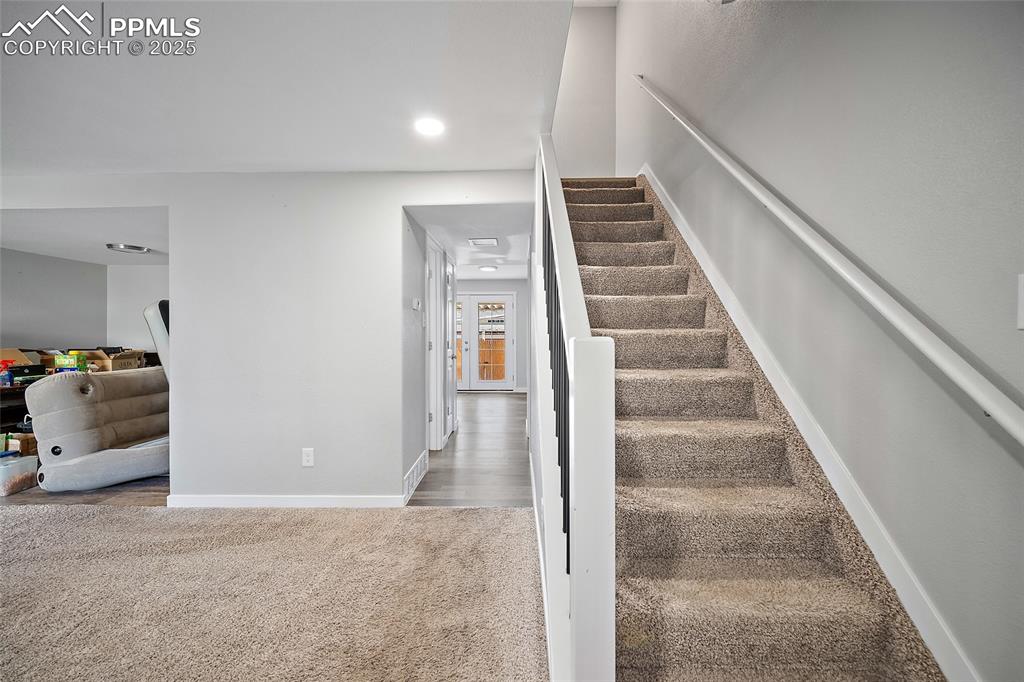 Image 11 of 34: Staircase featuring carpet floors and recessed lighting