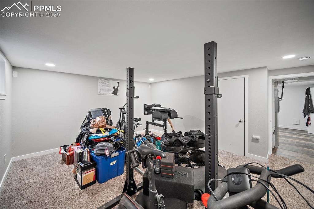 Image 18 of 34: Exercise area with carpet floors and recessed lighting