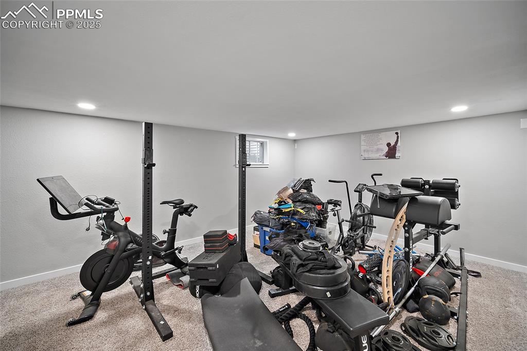 Image 19 of 34: Workout room with light carpet and recessed lighting