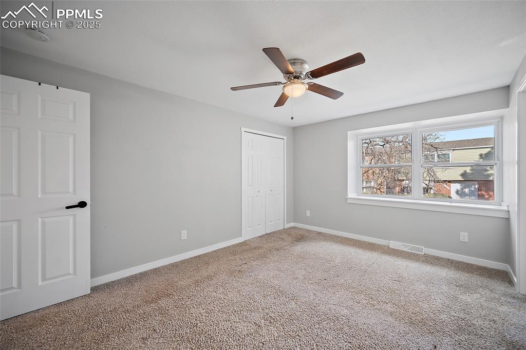 Image 21 of 34: Unfurnished bedroom with carpet floors, a closet, and ceiling fan