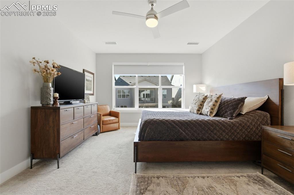 Image 23 of 50: Primary bedroom suite showing Graber shades with blackout liner 