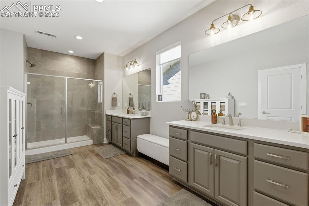 Image 25 of 50: Raised vanities, floor to ceiling tile, Hinkley lighting