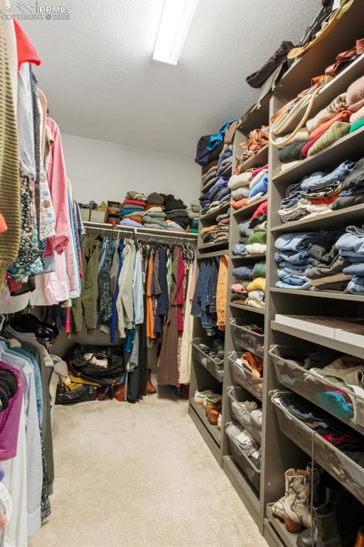 Image 27 of 50: Primary closet with closet system