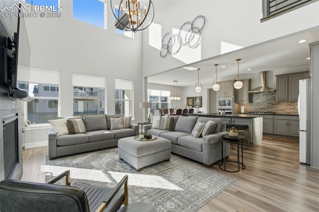 Image 3 of 50: Great room showcasing open concept, natural light, and Graber shades