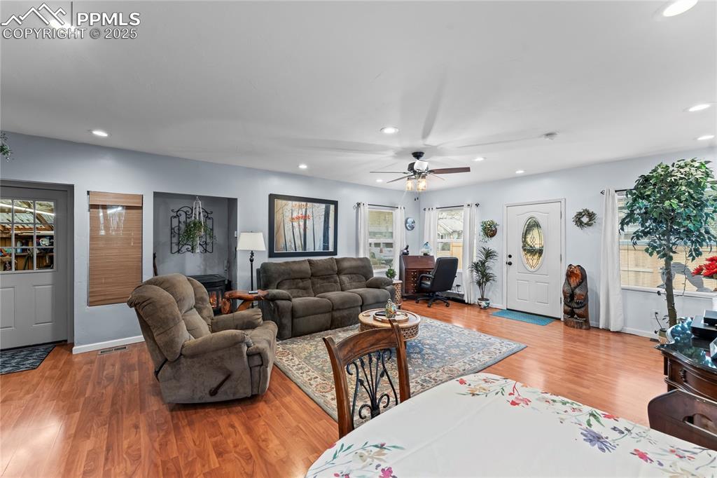 Image 10 of 27: Living area featuring light wood-type flooring, recessed lighting, and ceil
