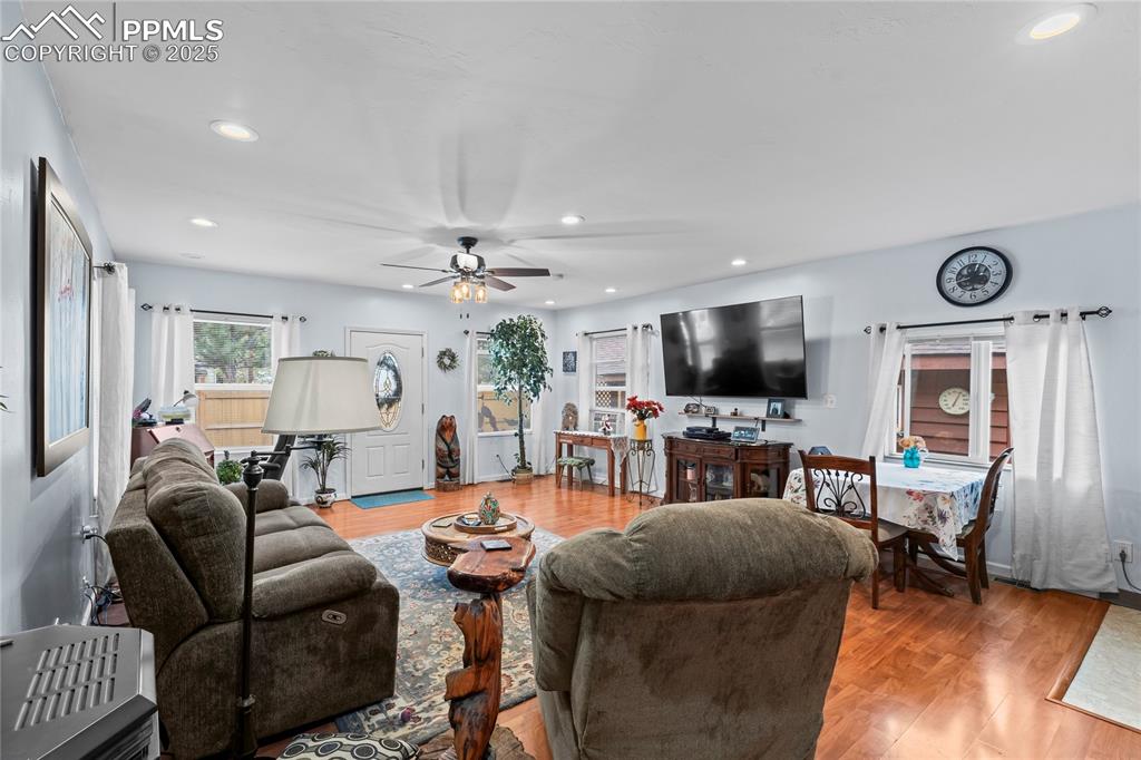 Image 11 of 27: Living room featuring recessed lighting, light wood finished floors, and ce