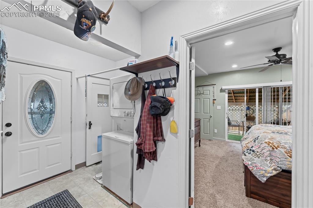 Image 13 of 27: Washroom featuring recessed lighting, light carpet, stacked washing machine