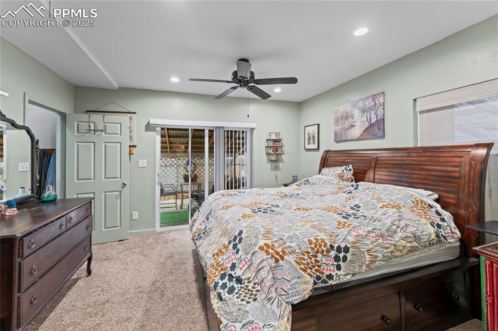 Image 14 of 27: Carpeted bedroom featuring access to exterior, ceiling fan, and recessed li