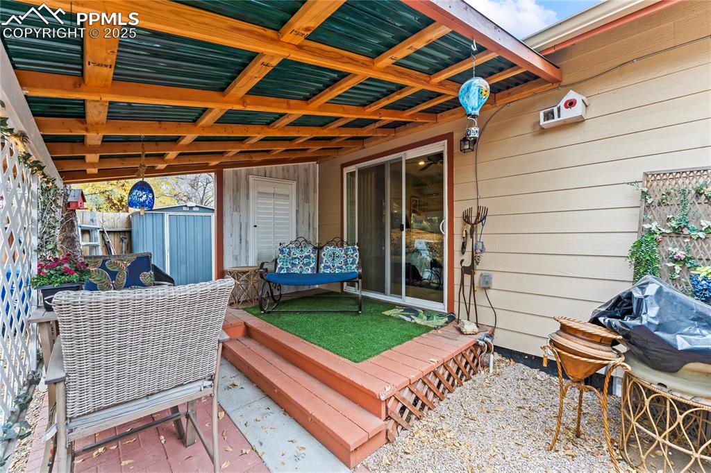 Image 19 of 27: Wooden deck featuring a shed