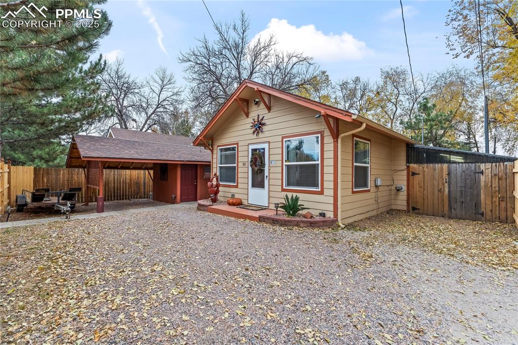 Image 2 of 27: View of front of house with driveway and a shingled roof