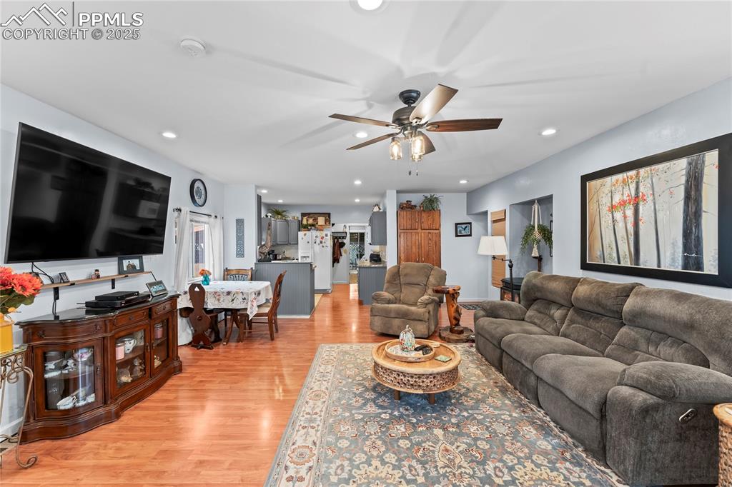 Image 3 of 27: Living area with light wood-style flooring, recessed lighting, and a ceilin
