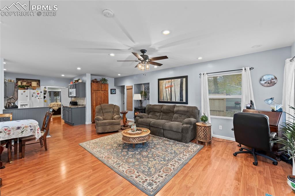Image 4 of 27: Living room featuring light wood-style floors, recessed lighting, a ceiling