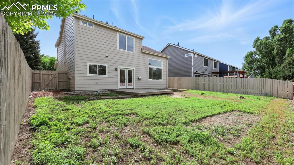 Image 40 of 50: Spacious yard with ample space for play, gardening, and outdoor entertainin