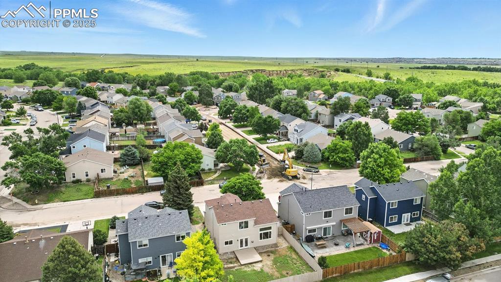 Image 50 of 50: Aerial rear view of home and neighborhood including lots of green open spac