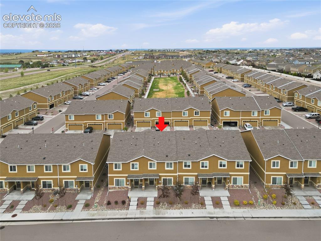 Image 38 of 48: Terraced townhome featuring a two-story design with a dedicated garage