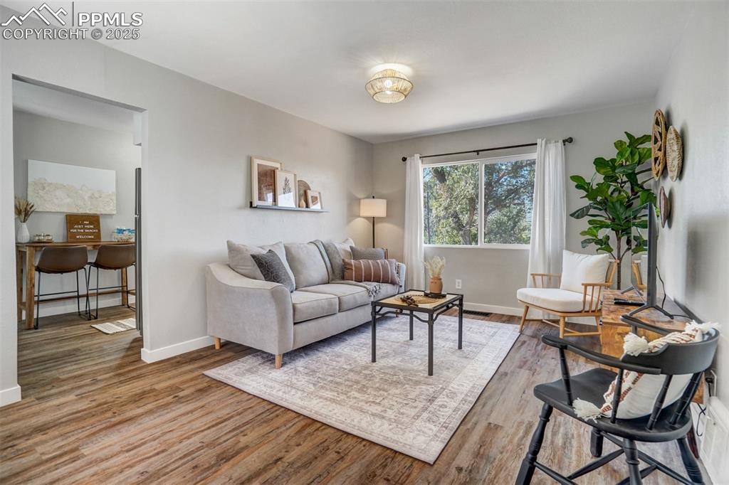 Image 15 of 24: Living area with wood finished floors and baseboards