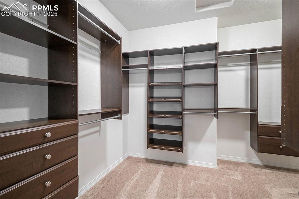 Image 27 of 44: Custom walk in closet off primary bath