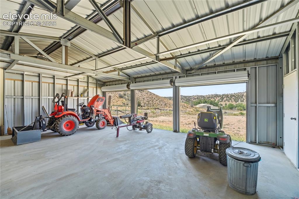 Image 22 of 49: Metal framed structure with a corrugated metal roof, corrugated metal sidin