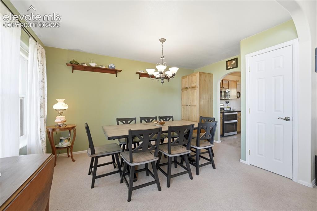 Image 30 of 49: Recessed window, arched entryway, overhead chandelier, built-in cabinetry,