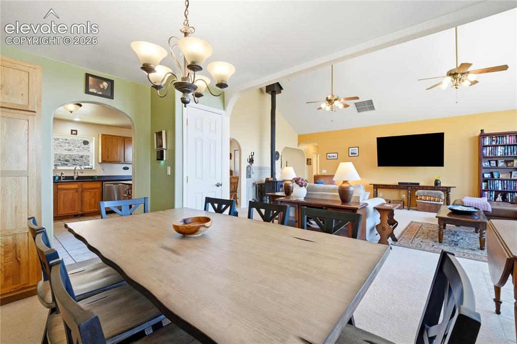 Image 31 of 49: Vaulted ceilings, archway entries, and a multi-light chandelier enhance the