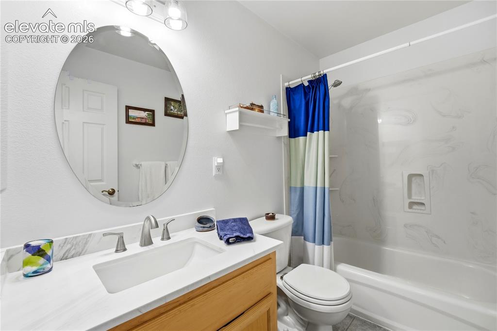 Image 36 of 49: Vanity with white countertop, undermount sink, and brushed nickel faucet