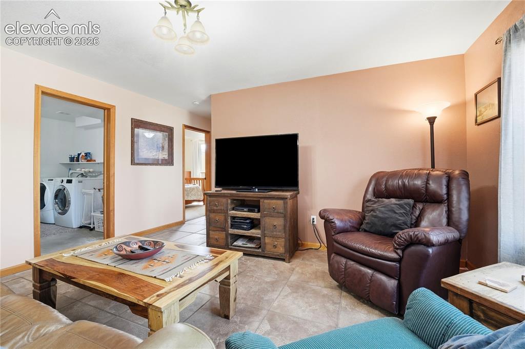 Image 37 of 49: Tile flooring, wood-finish trim, built-in media console, ceiling-mounted li