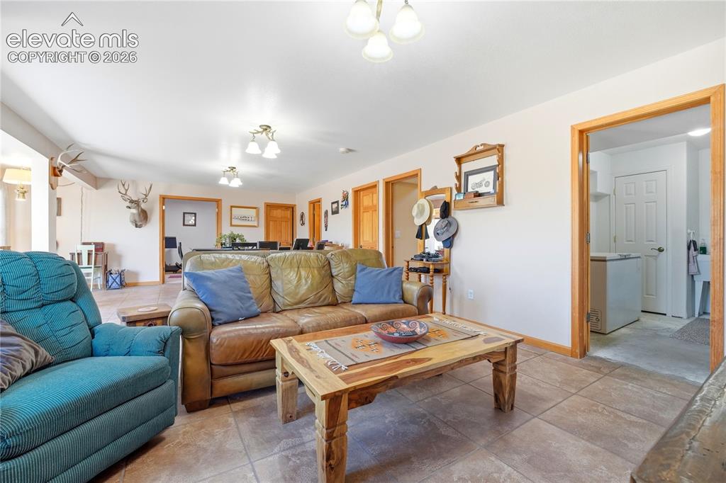 Image 40 of 49: Spacious room featuring tile flooring, light-toned walls, recessed lighting