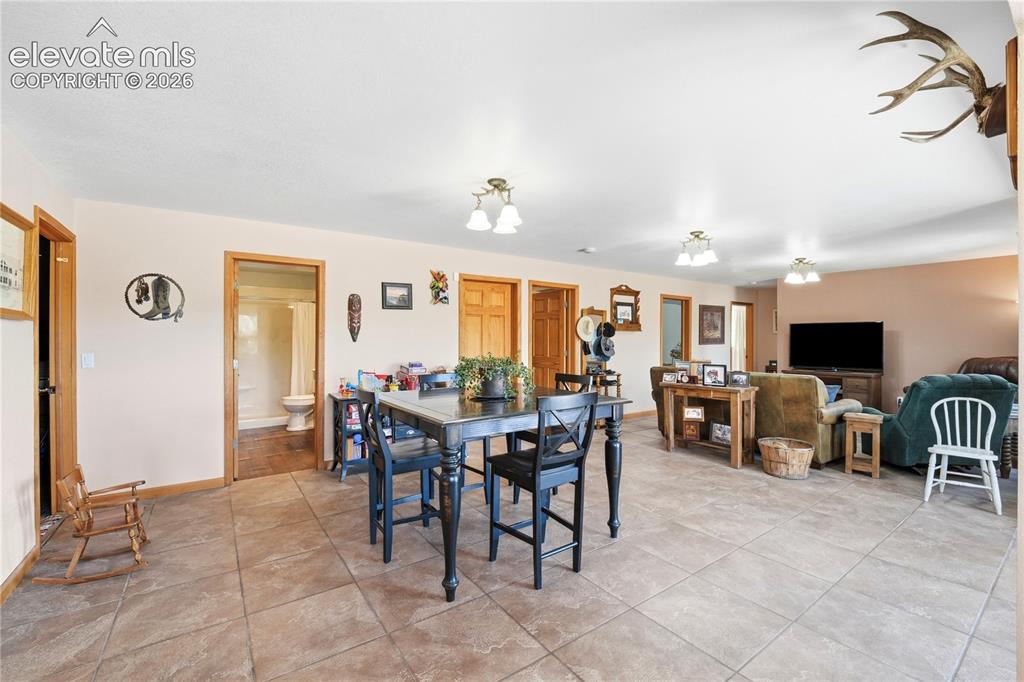 Image 42 of 49: Ceramic tile flooring extends through the dining area and into the entryway