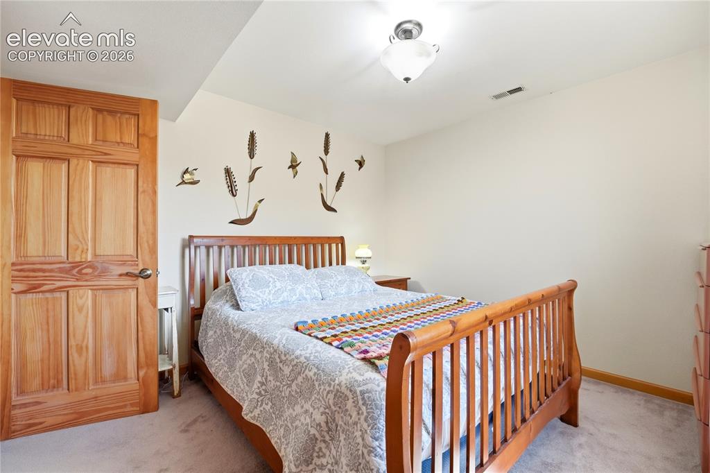 Image 43 of 49: Carpeted flooring with light-colored walls and a semi-flush mount ceiling l
