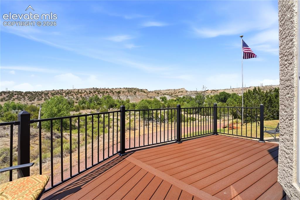 Image 9 of 49: Expansive outdoor decking with composite wood-finish boards and black metal