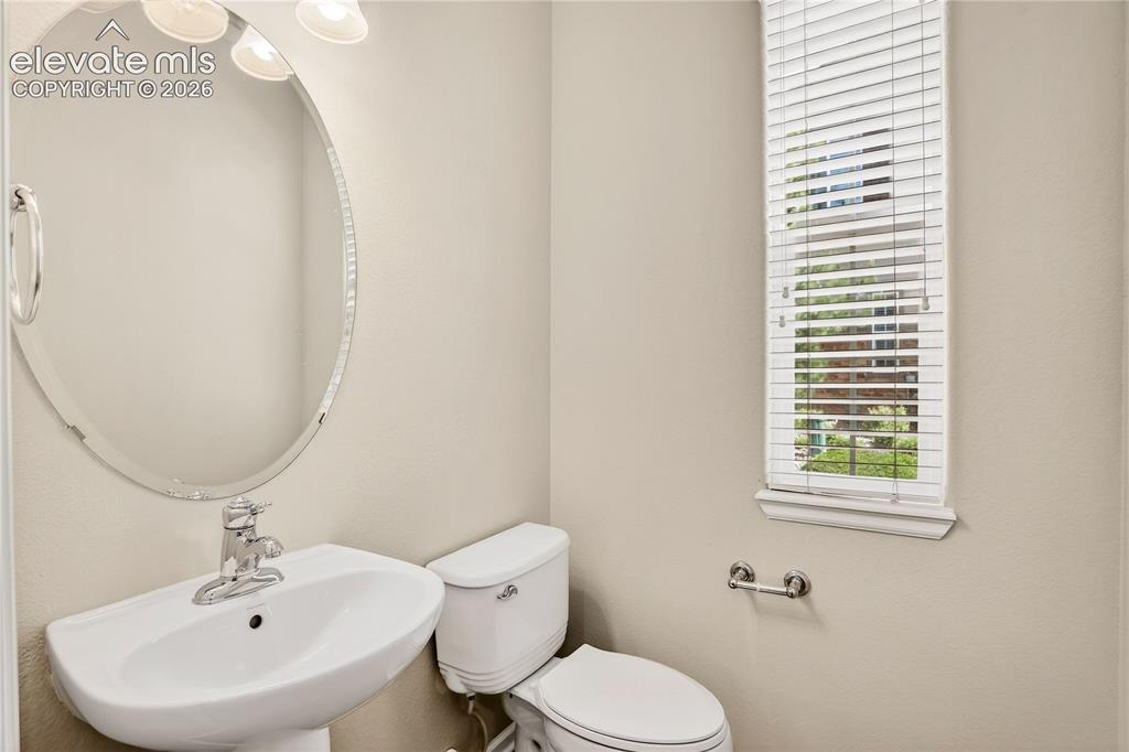 Image 16 of 41: View from kitchen of garage access, laundry area and powder bath.