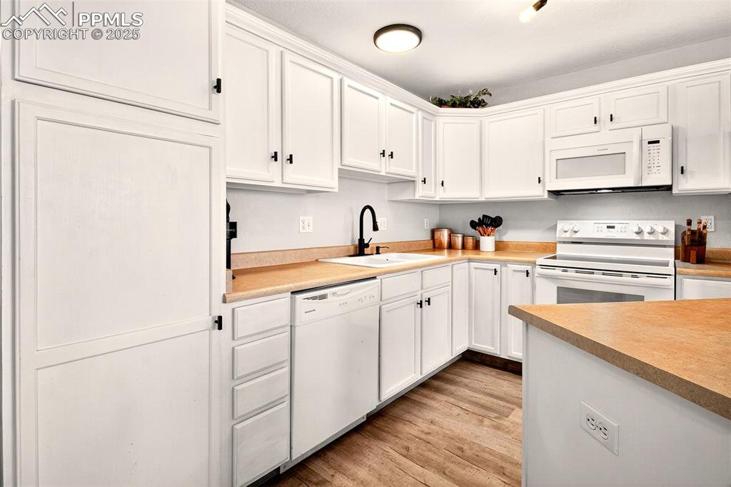 Image 7 of 21: Kitchen featuring cabinets, appliances and pantry