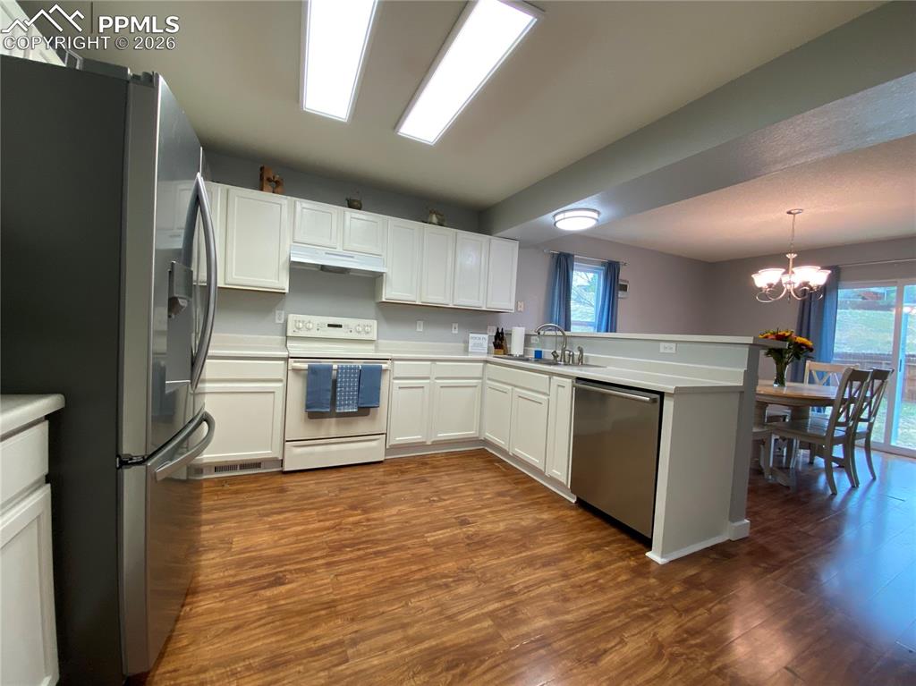Image 16 of 34: Newly painted kitchen cabinets look sleek