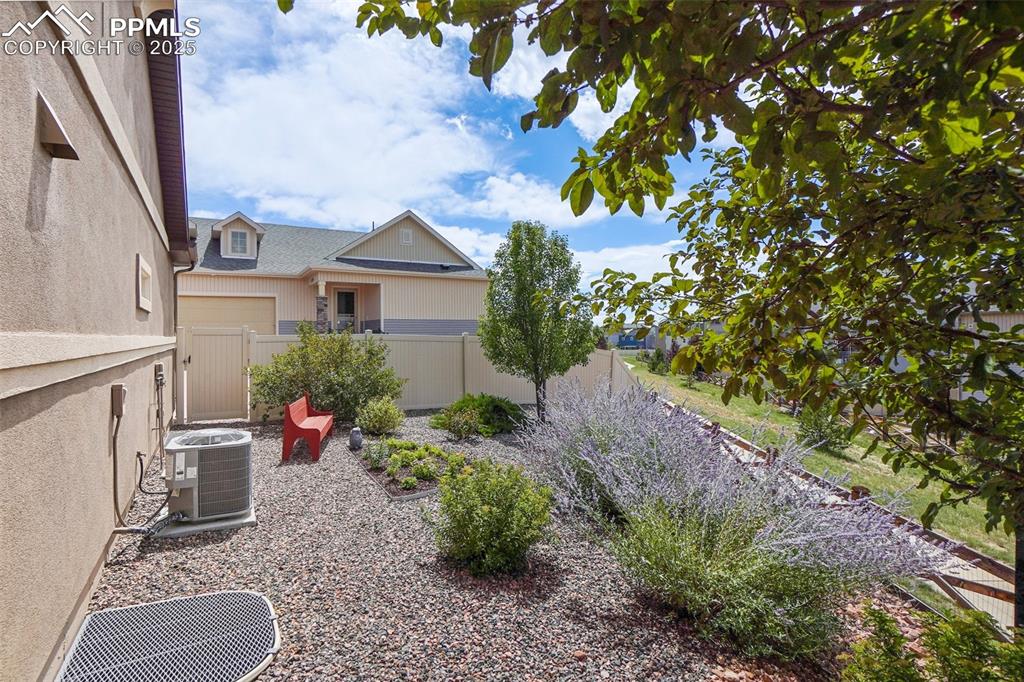 Image 40 of 48: View of yard featuring cooling unit and fence