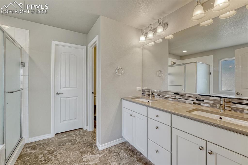 Image 13 of 45: Unwind in style in the primary bathroom, featuring a spa-inspired shower st